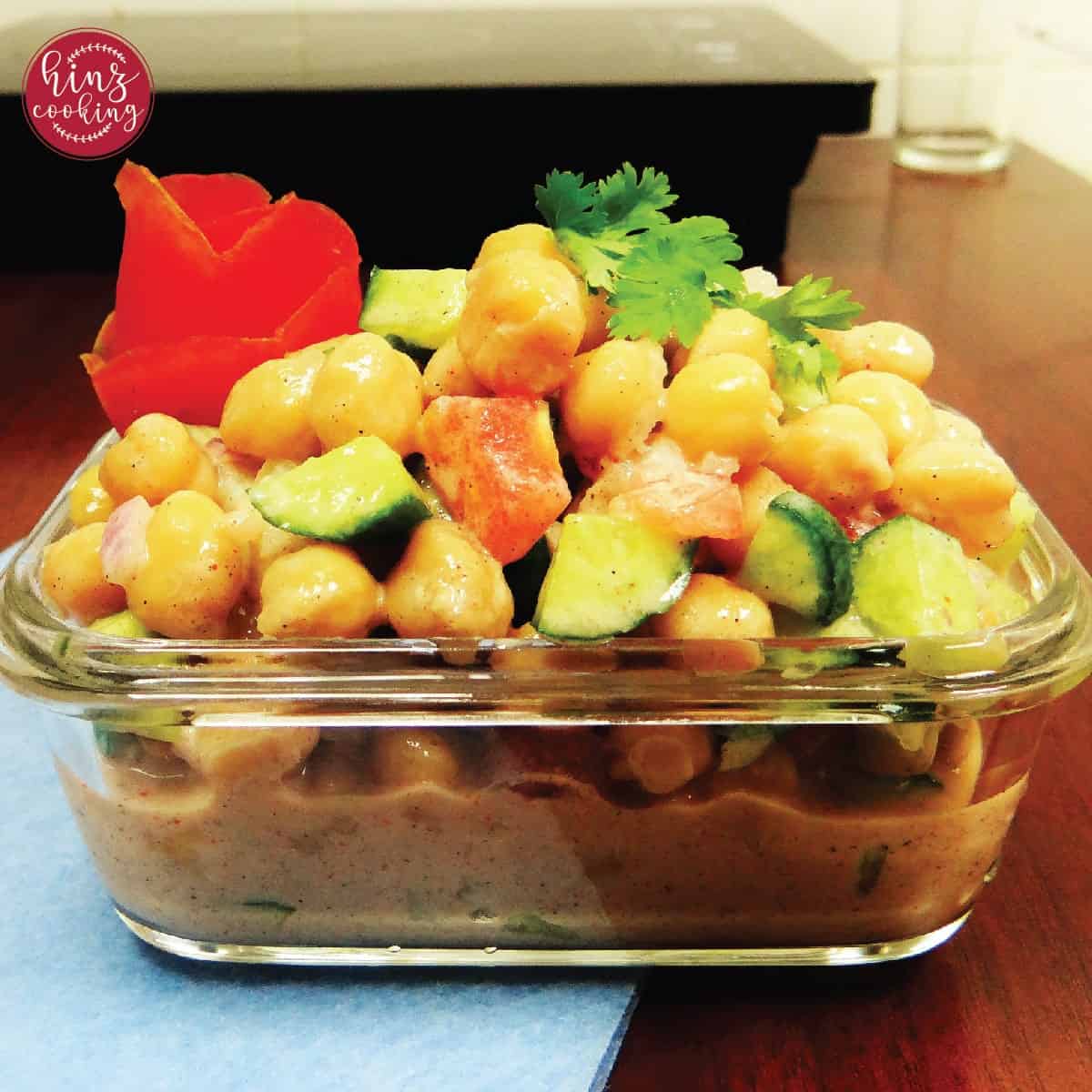 bowl of Indian chickpea salad packed with veggies and yogurt salad dressing