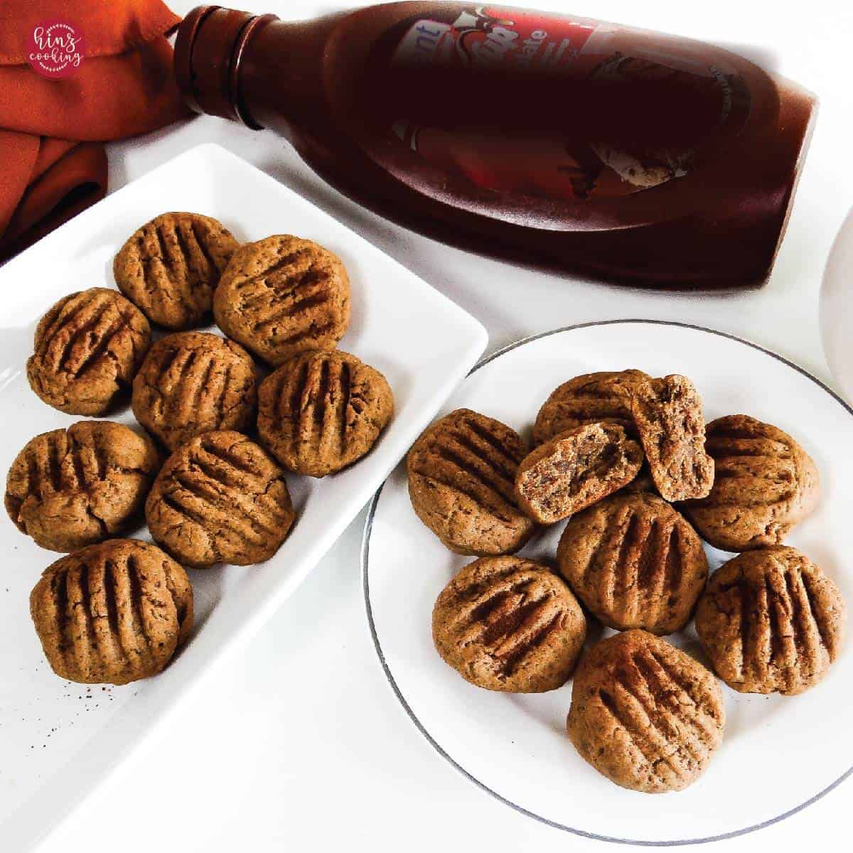 8 coffee cookies in a rectangular platter and 6 cookies on a round plate. White background.
