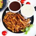 five guys cajun fries in a plate with 2 sauces