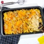 Cajun chicken mac and cheese baked in black baking dish.